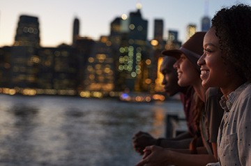 friends watching sunset, city skyline behind