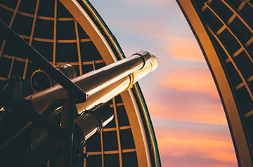 An image of a telescope emerging from an observatory