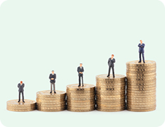 miniature toy businessmen on stacks of coins