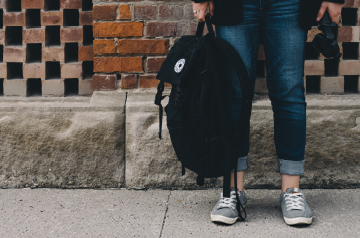 person holding backpack