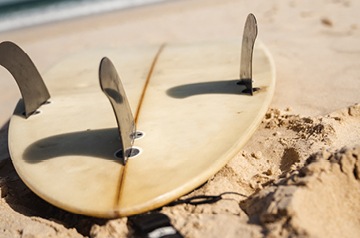 surfboard left on beach