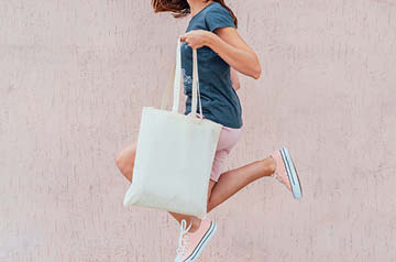 jumping in front of pink wall