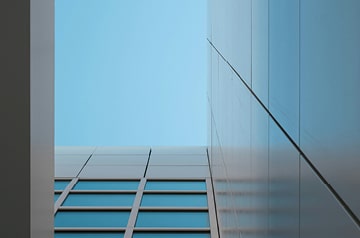 Blue sky viewed from between buildings.