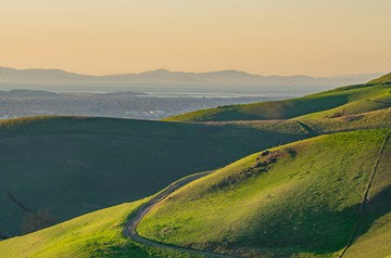 Grassy rolling hills fading off in the haze