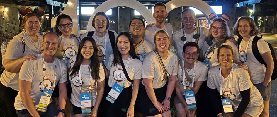 People posing for a photo at a conference