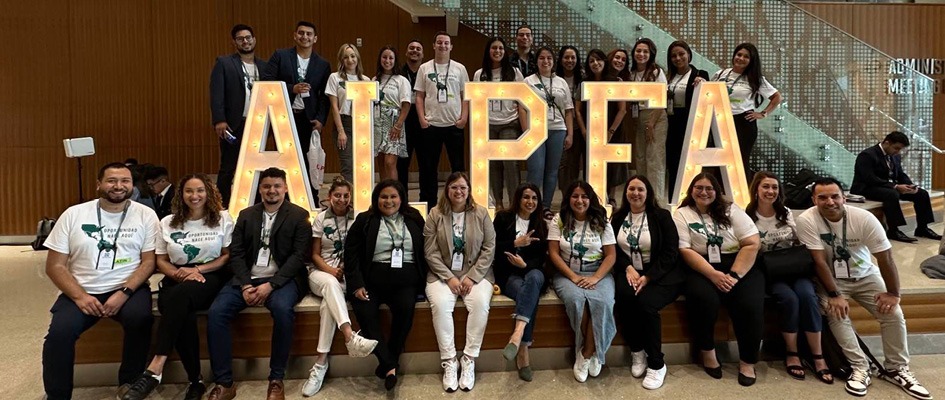 People posing for a photo at a conference