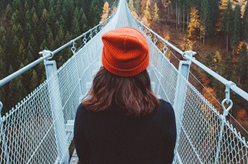 standing on suspension bridge