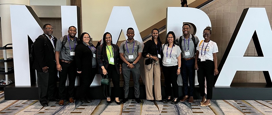 People posing for a photo at a conference