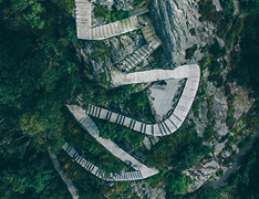 aerial view of hikers on trail with stairs and switchbacks