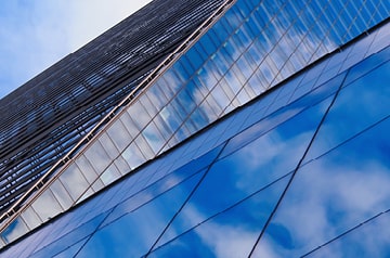 Clouds reflected in the glass windows of a skyscraper