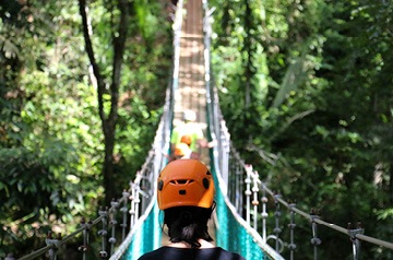 hikers crossing suspension bridge