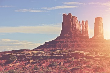 The Castle Rock formation in Monument Valley Navajo Tribal Park glowing in the sunlight.