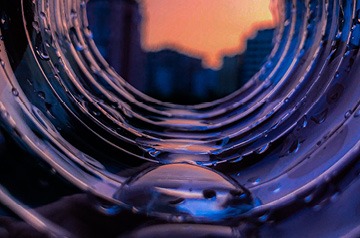 view of city through drainage pipe