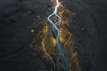 River flowing through flatland at sunset.