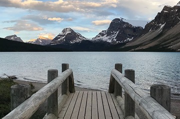 wooden path to mountain lake and beach