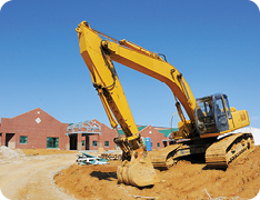 excavator breaking ground at construction site