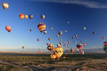 Hot air balloons floating in a clear blue sky
