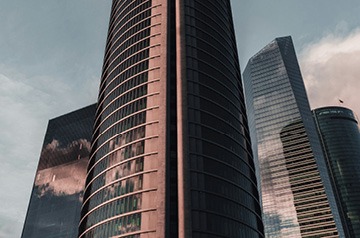 Glass-sided skyscrapers against blue sky