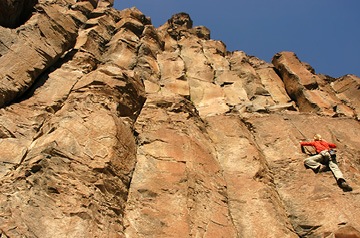 rock climber ascending cliff face